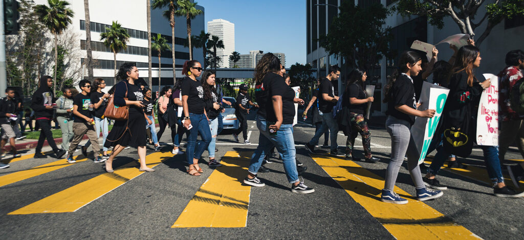 image of youth at a protest crossing the street